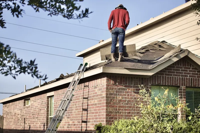 Professional roofer working on a residential roof in Somerall
